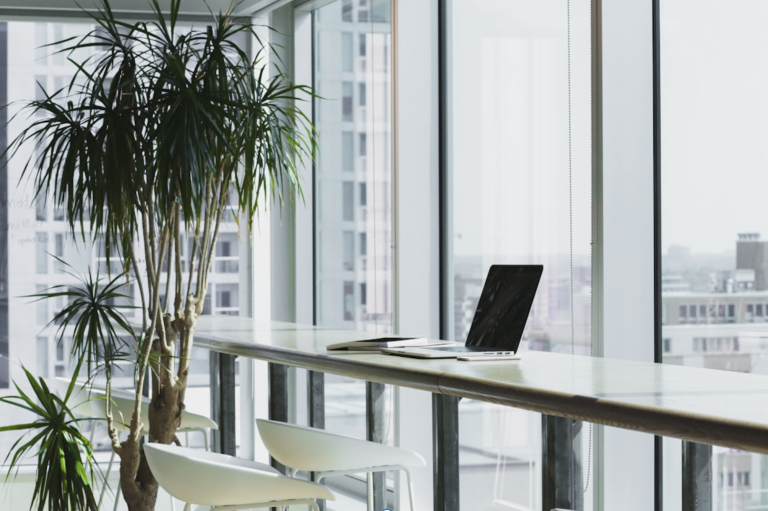 A laptop on a table by a window, highlighting the best enterprise AI platform for productivity and innovation.